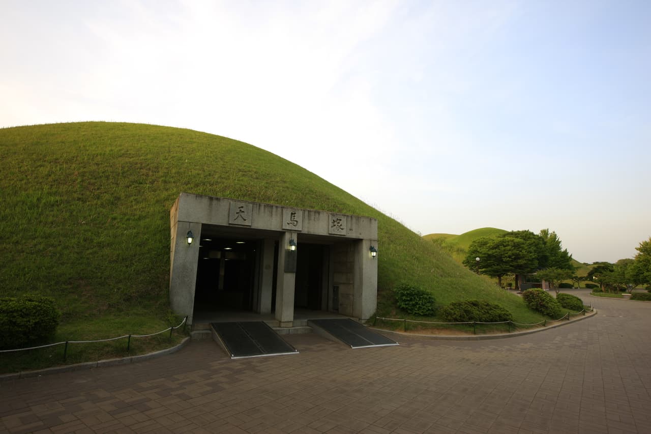 The grassy royal burial mounds of Daereungwon with the Cheonmachong tomb entrance, Gyeongju