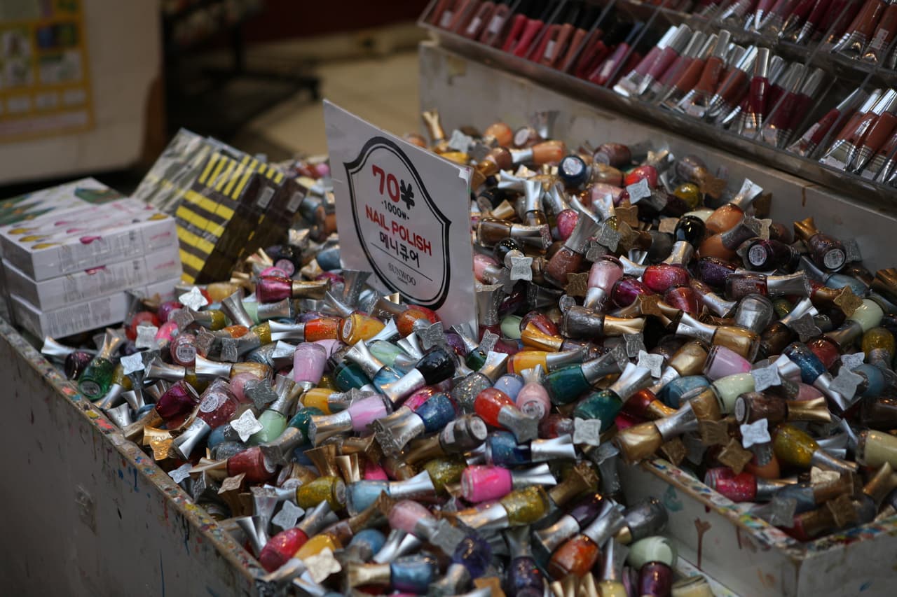 A market display of colorful nail polish and cosmetics for sale in Myeongdong, Seoul