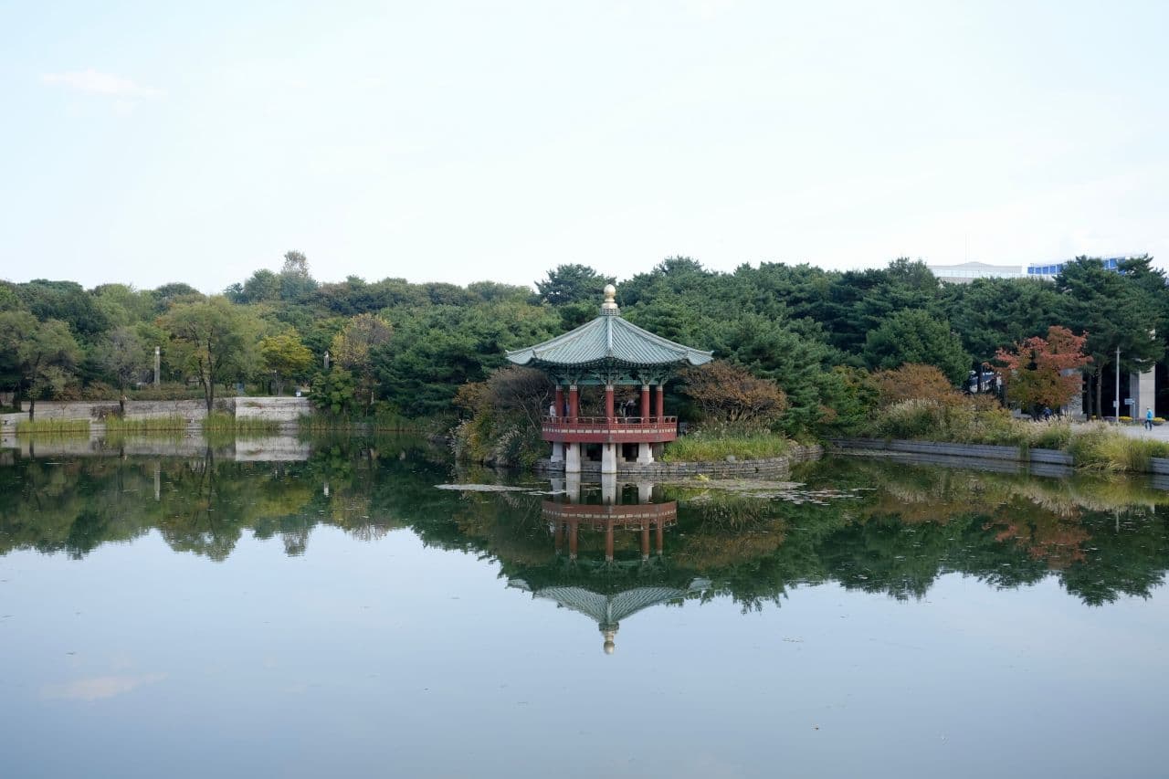 A traditional Korean pavilion reflected in the still pond in the grounds of the National Museum of Korea