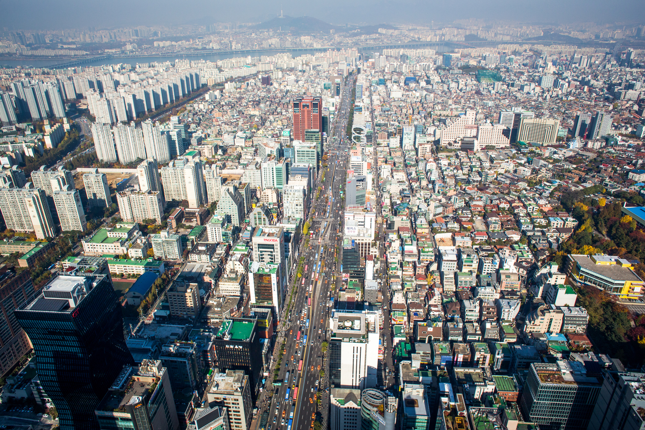 An aerial view of Gangnam's dense cityscape and wide boulevards in Seoul