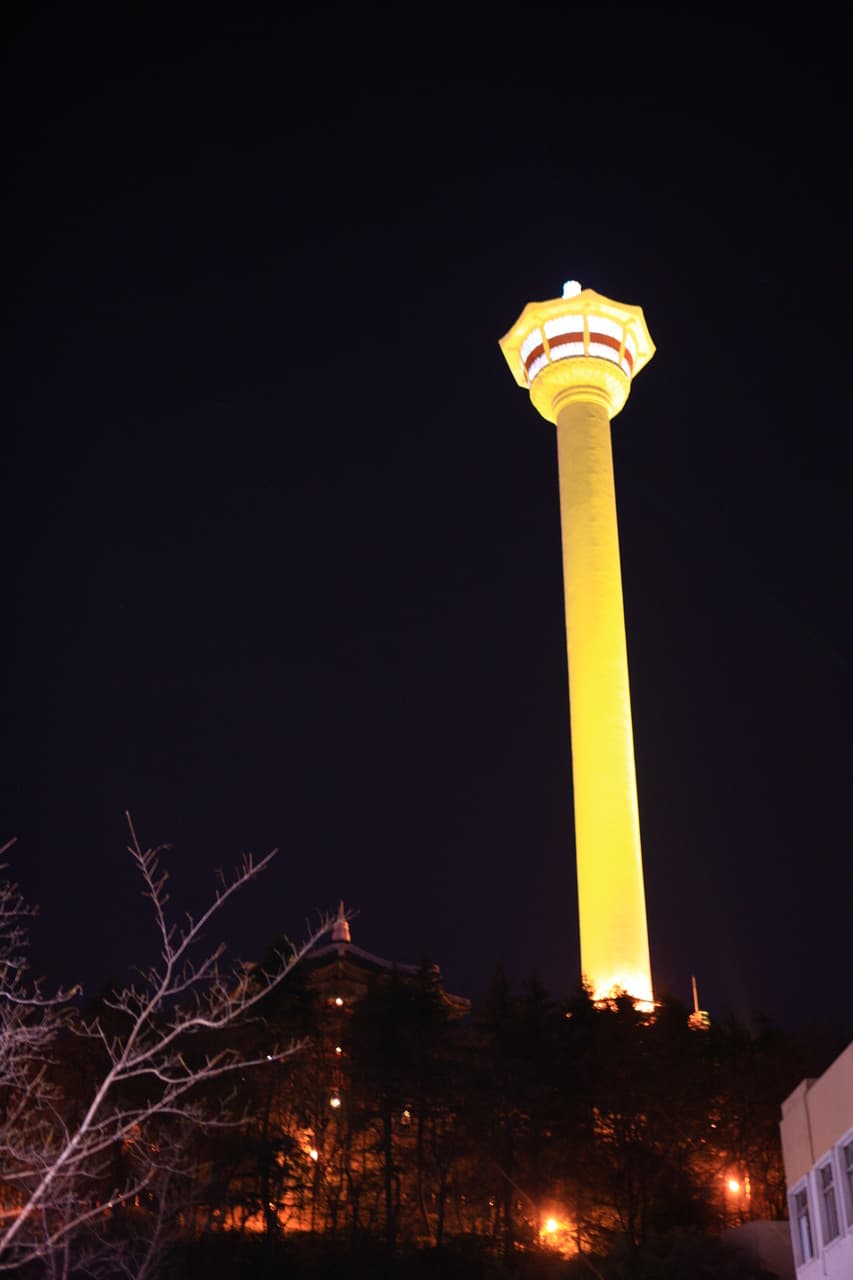 Busan Tower lit at night above Yongdusan Park, near Nampo, Busan