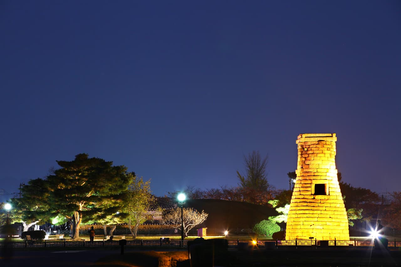 The ancient Cheomseongdae stone observatory lit at dusk in Gyeongju