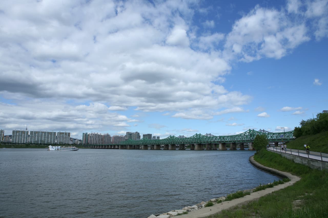 The Han River with a bridge and a riverside path in Seoul
