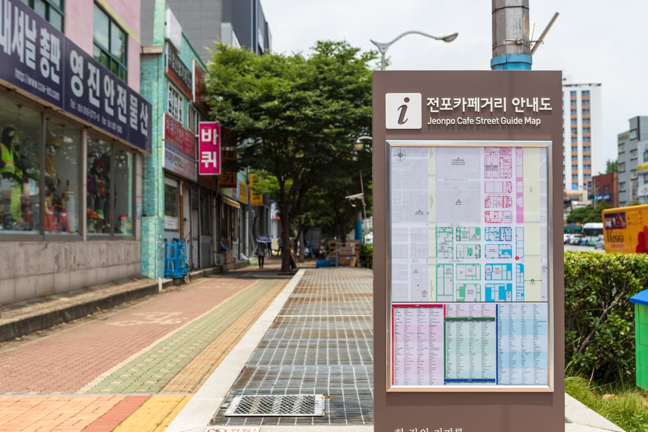 A street of cafes with a guide sign on Jeonpo Cafe Street near Seomyeon, Busan