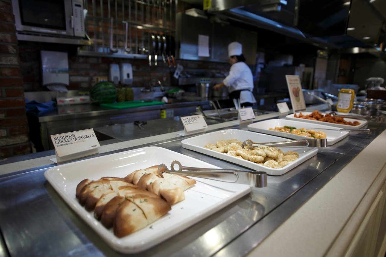 A casual buffet line of labeled dishes at a mall restaurant in Korea