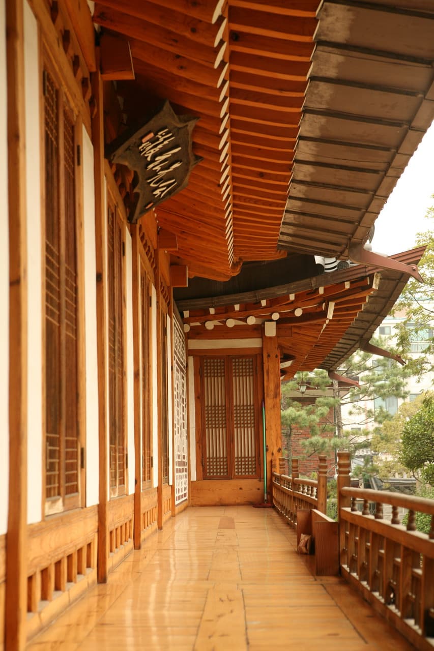 A wooden veranda and tiled eaves of a traditional hanok house in Bukchon, Seoul