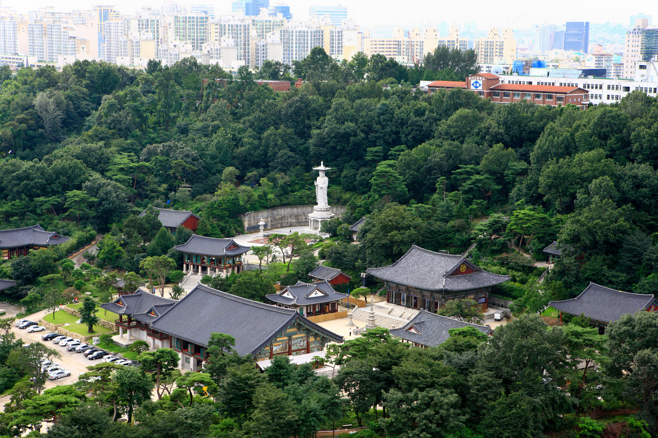 Bongeunsa temple in green grounds with the modern Gangnam skyline behind, Seoul