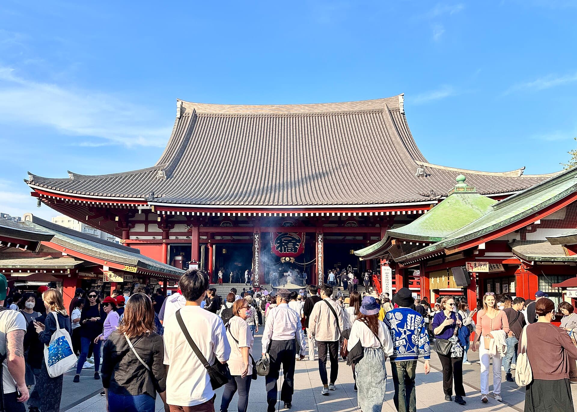 The main hall of Sensoji temple in Asakusa, Tokyo, with a tiled roof and red timber facade