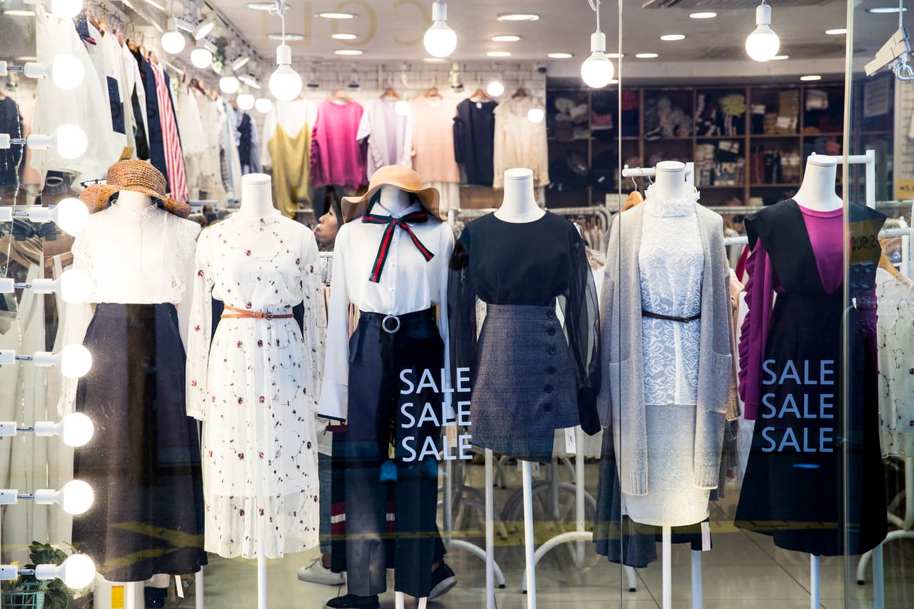 A clothing shop window display with mannequins in Myeongdong, Seoul