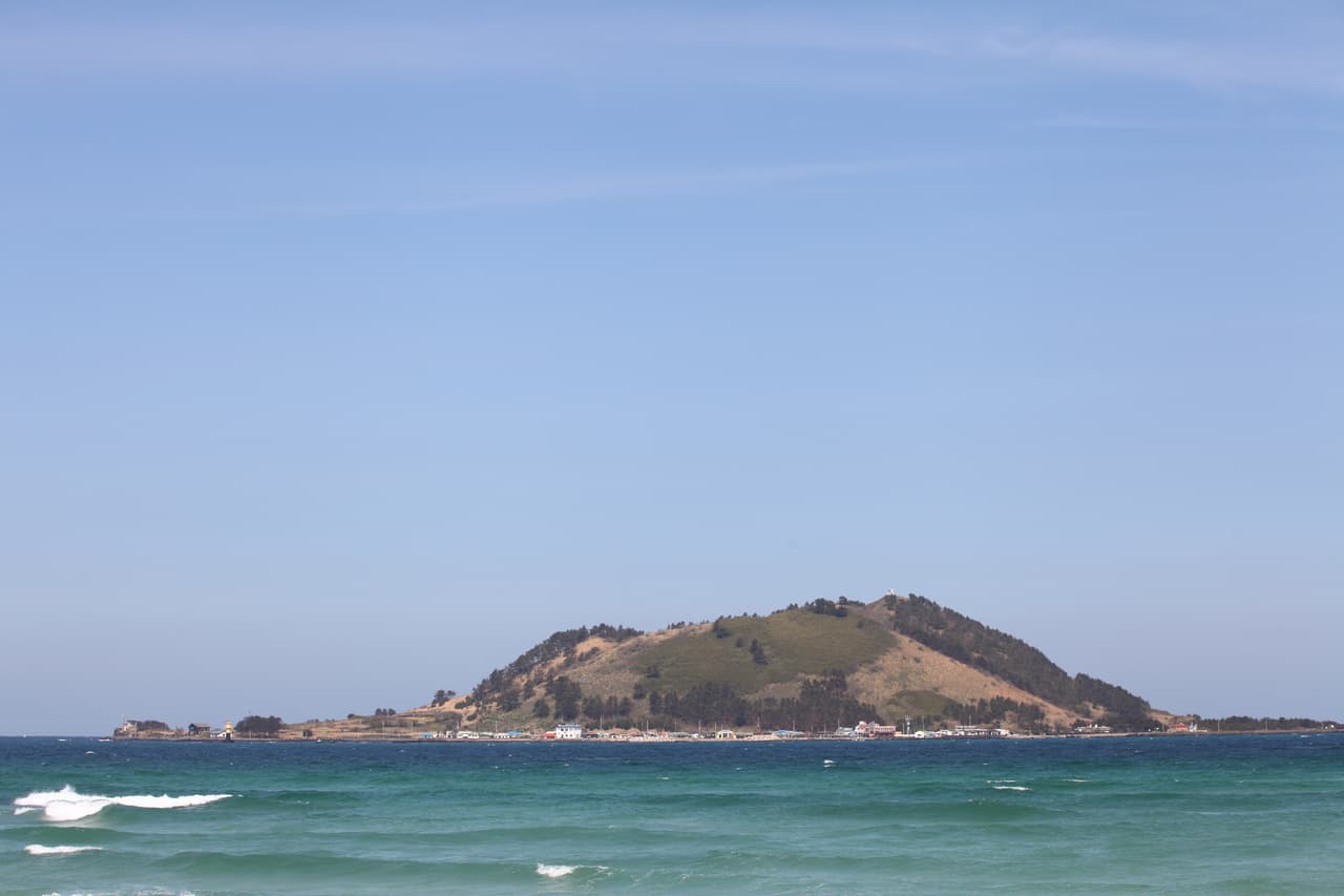 Biyangdo Island seen across turquoise water from Jeju's west coast near Hyeopjae