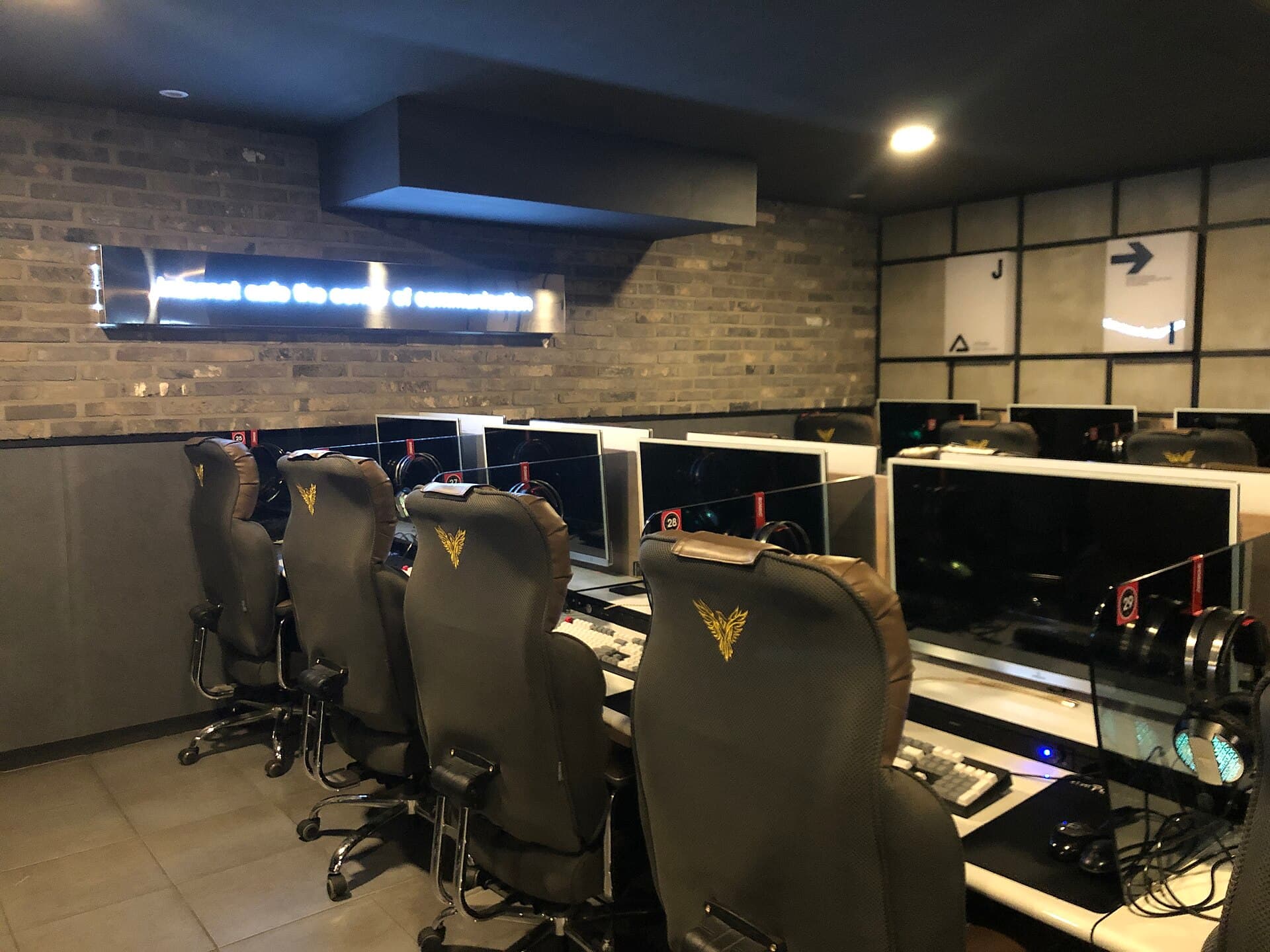 Rows of empty gaming chairs and monitors inside a Korean PC bang