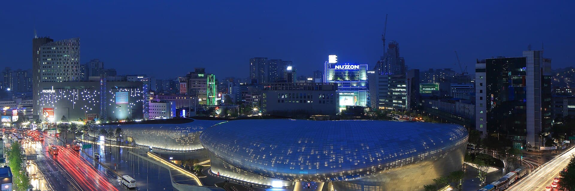 Dongdaemun Design Plaza's curved architecture lit up at night