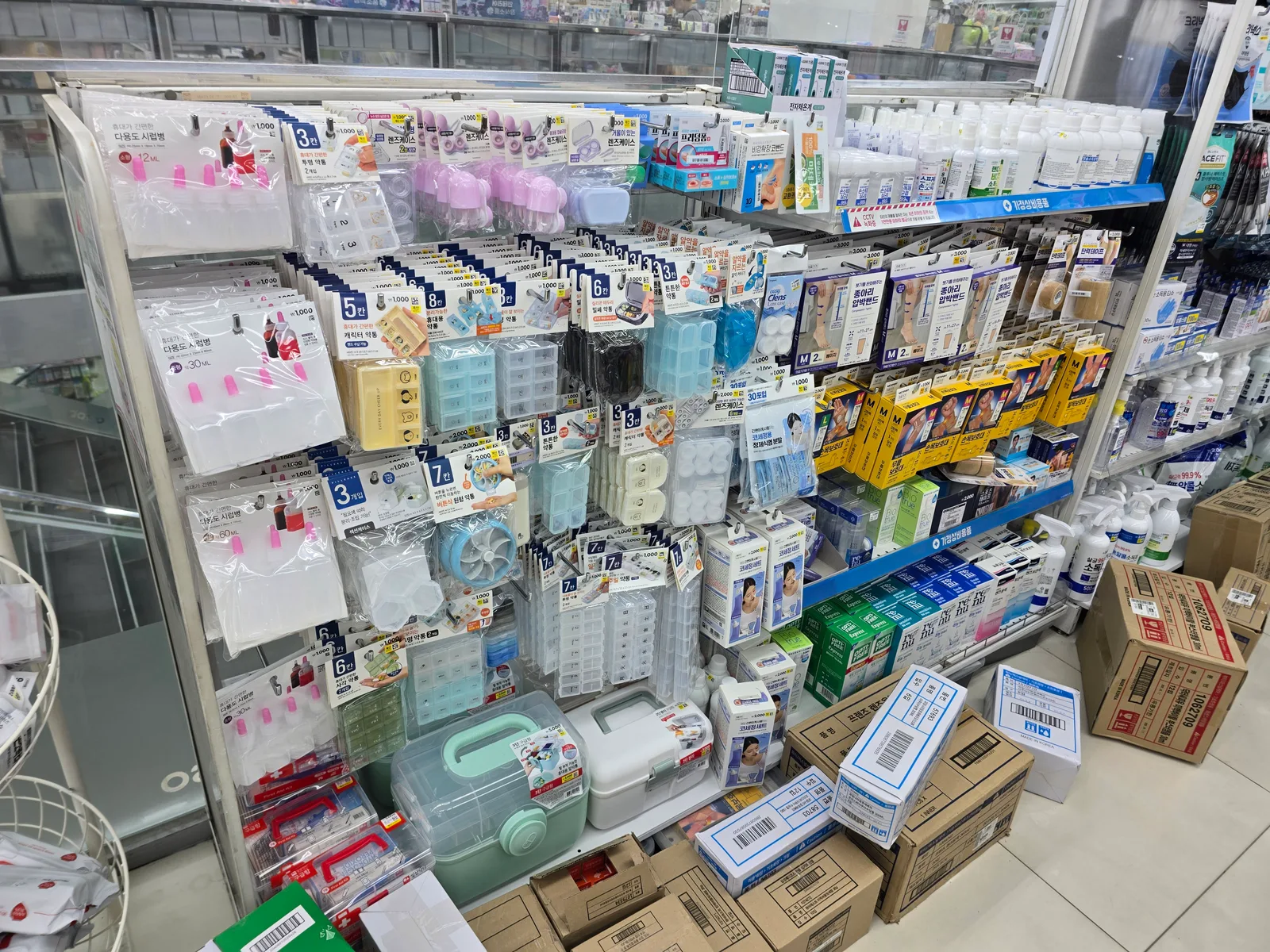 Mesh packing organizers and travel pouches hanging in a Daiso aisle