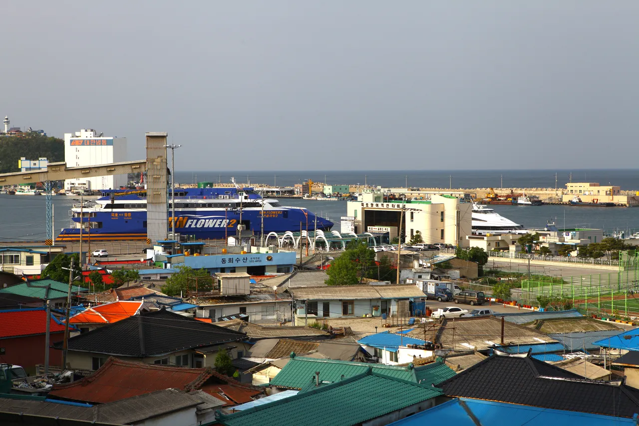 Mukho Port ferry terminal and harbor under a clear blue sky in Donghae