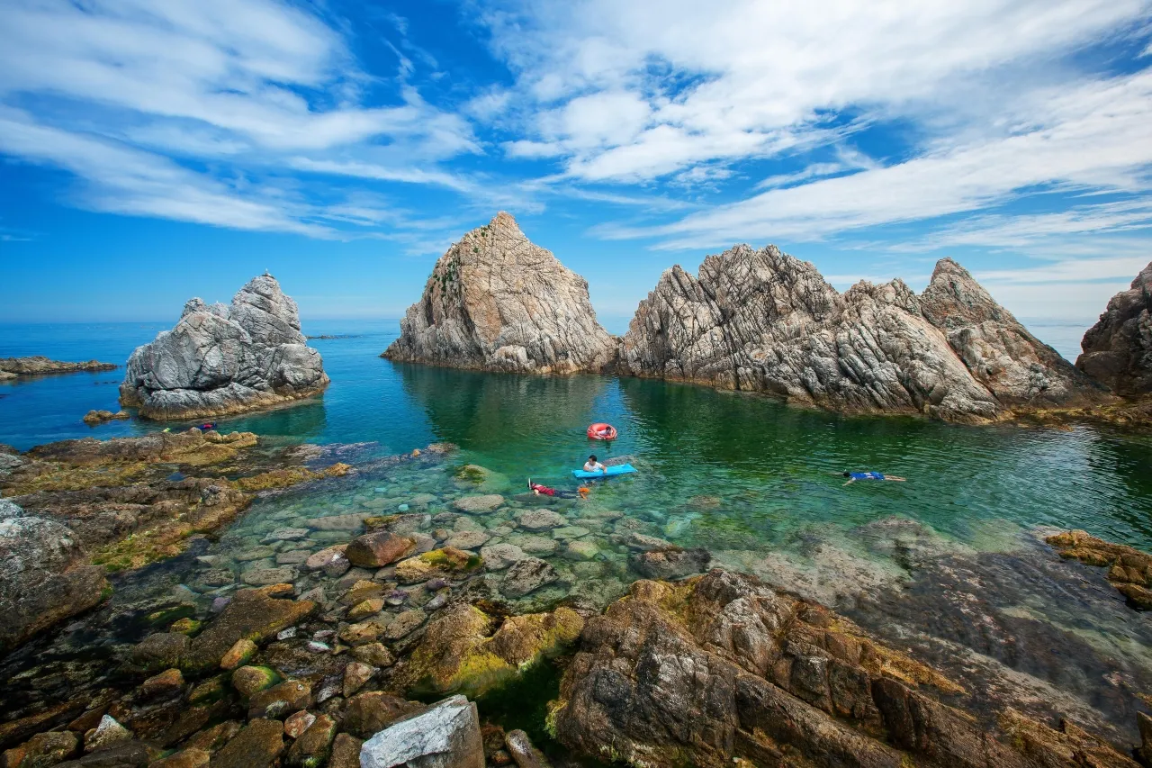 Turquoise bay and rocky headland at Jangho Port in Samcheok on a clear day