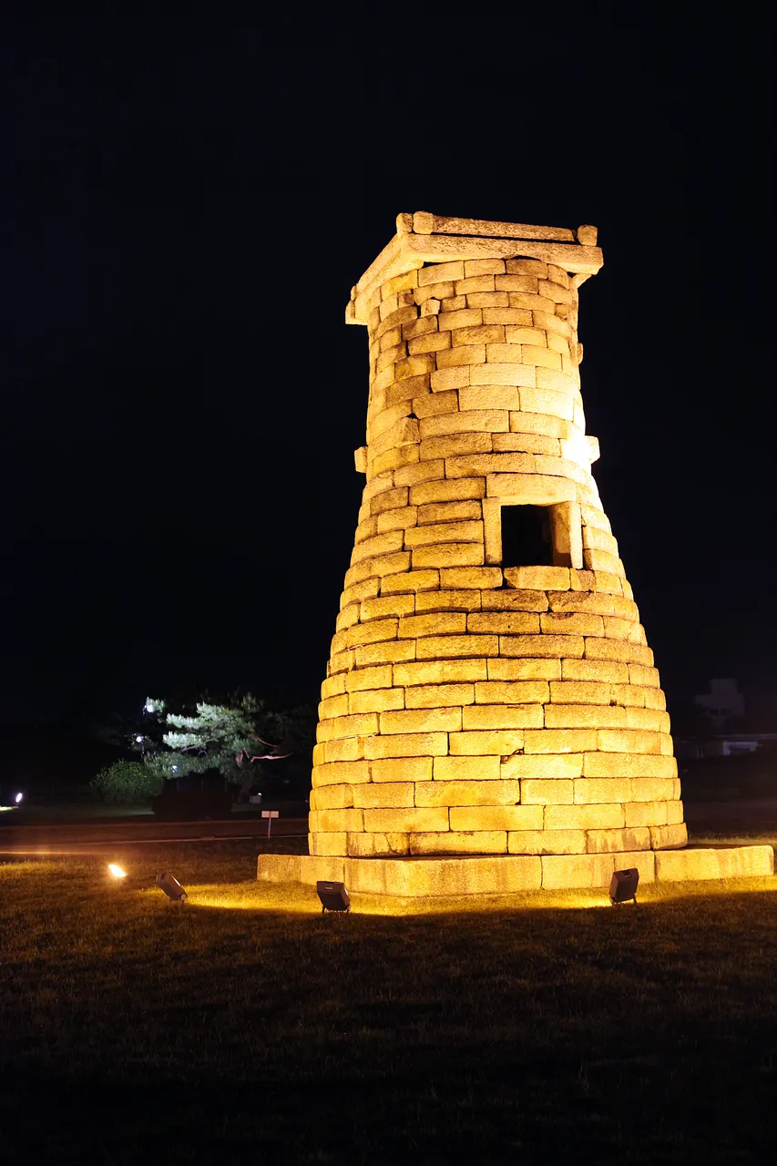 Cheomseongdae observatory tower lit up at night in Gyeongju