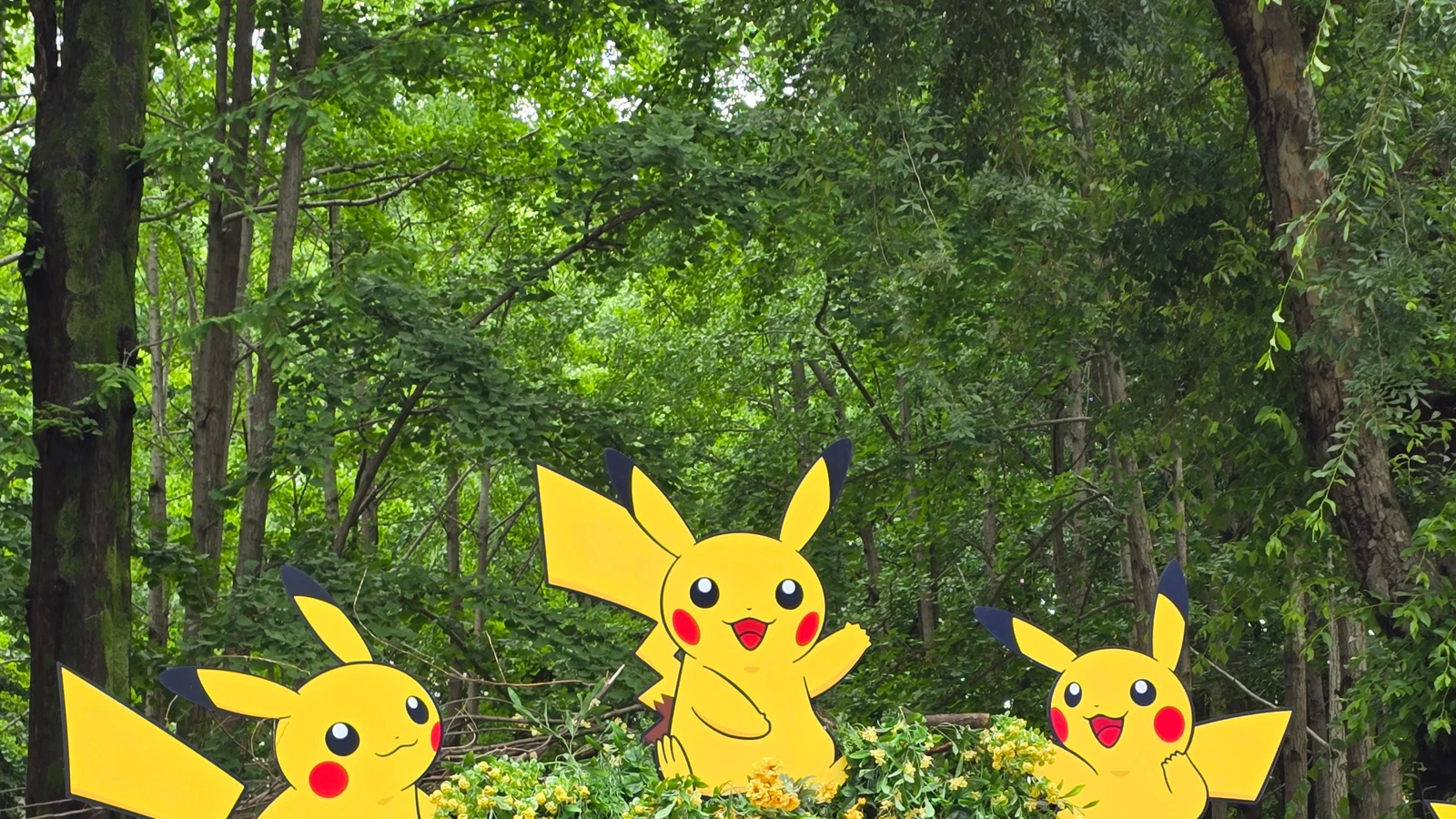 Large Pikachu and Eevee figures outside a storefront labeled Pokémon Center Korea at night