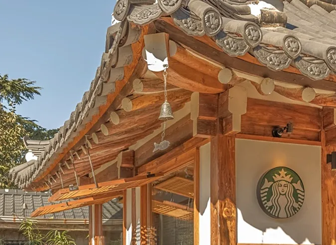 Starbucks Insadong storefront with a Hangul main sign on a traditional street at dusk