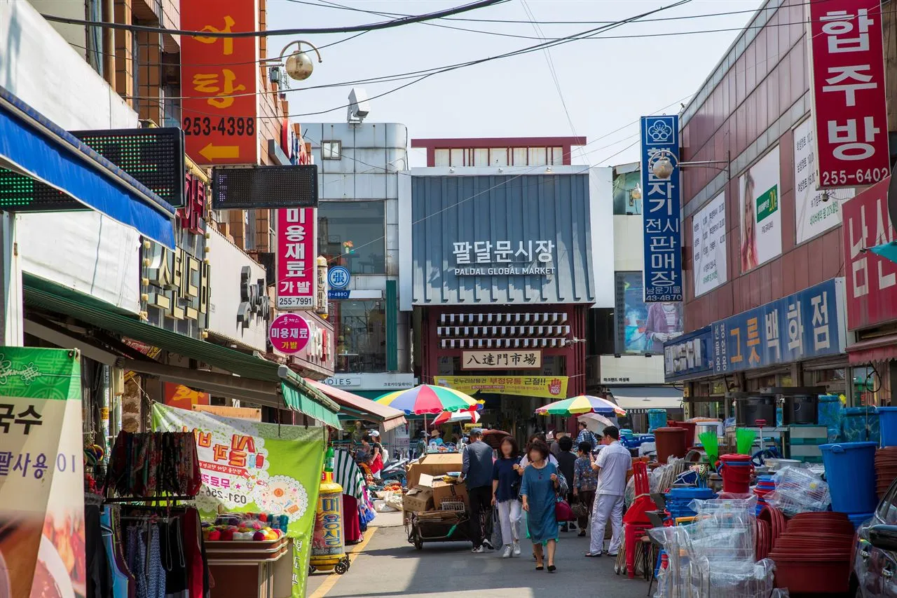 Paldalmun Gate rising above the traditional market district in Suwon at night